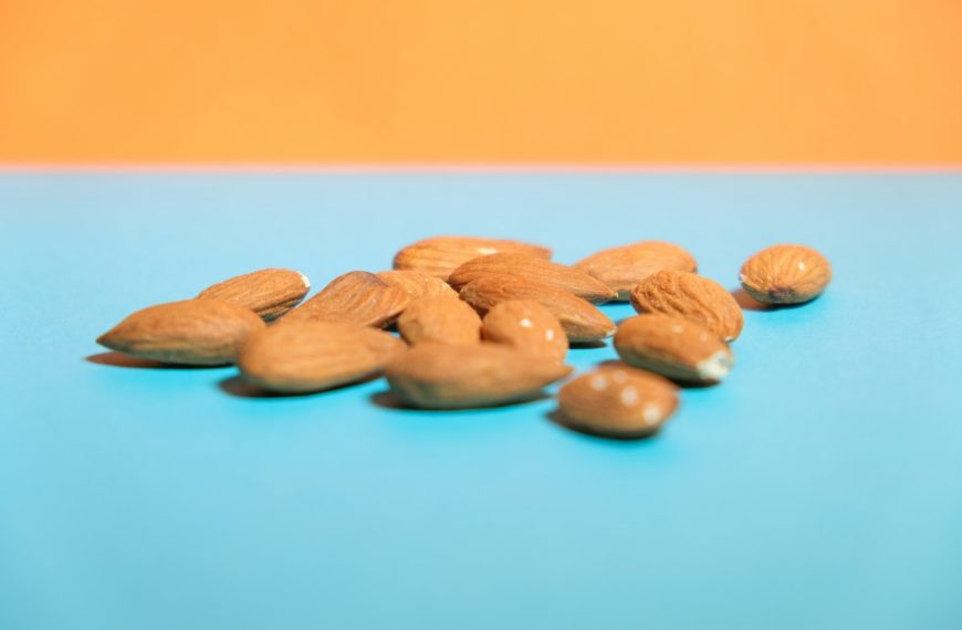 brown almond nuts on blue surface